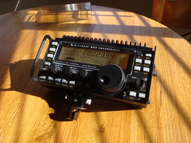 Elecraft KX3 transceiver on sunlit wooden table