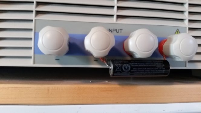 Four white input terminals with battery